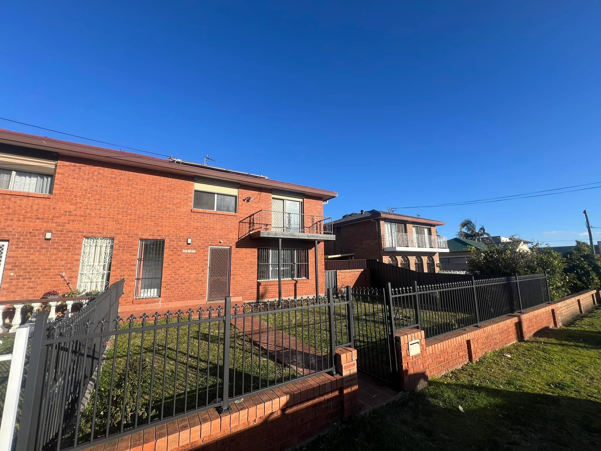 A red brick home exterior on a sunny day, typical of homes in the Shellharbour and Illawarra area
